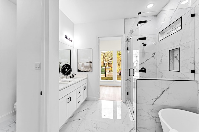 bathroom featuring plus walk in shower and vanity