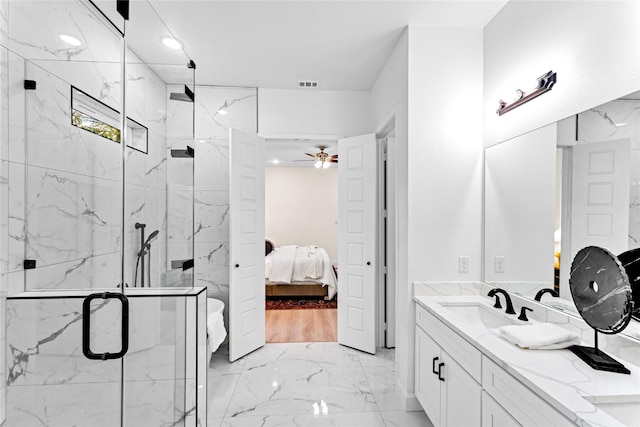 bathroom featuring an enclosed shower, vanity, and ceiling fan