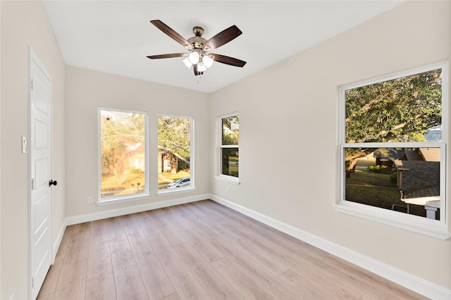 unfurnished room with ceiling fan and light wood-type flooring