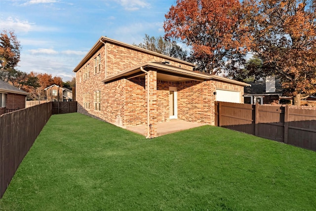 back of house with a patio area and a lawn