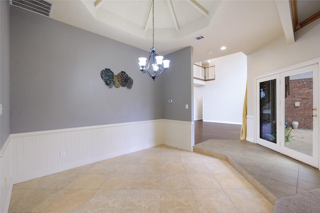 unfurnished room featuring light tile patterned floors and a chandelier