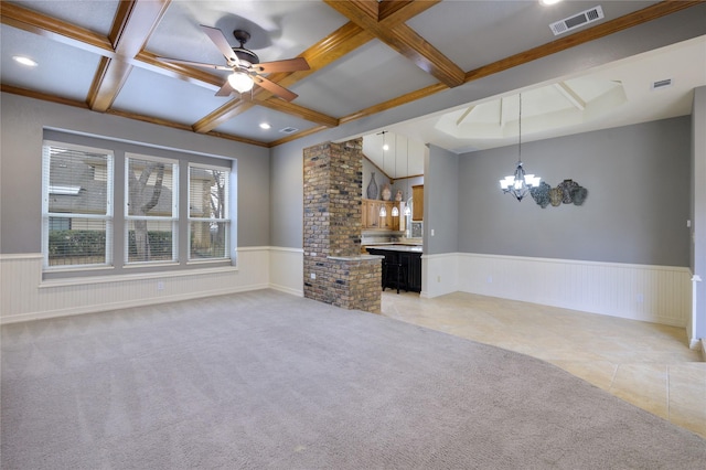 unfurnished living room with light carpet, beam ceiling, ceiling fan with notable chandelier, and coffered ceiling