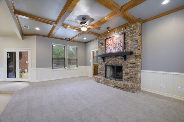 unfurnished living room featuring coffered ceiling, crown molding, a fireplace, beam ceiling, and light colored carpet