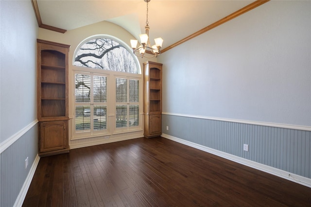 unfurnished room with dark hardwood / wood-style floors, crown molding, lofted ceiling, and a notable chandelier