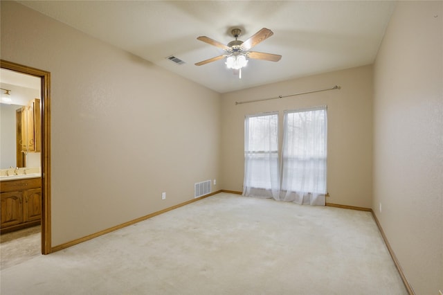 carpeted empty room with ceiling fan and sink