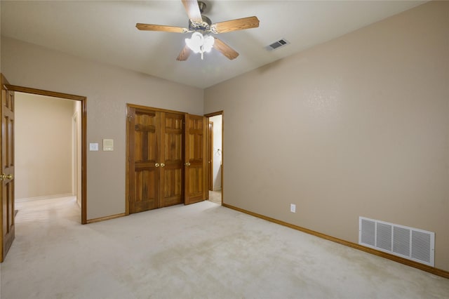 unfurnished bedroom with light colored carpet and ceiling fan