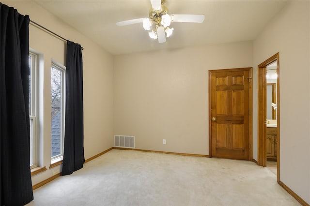 carpeted empty room featuring ceiling fan