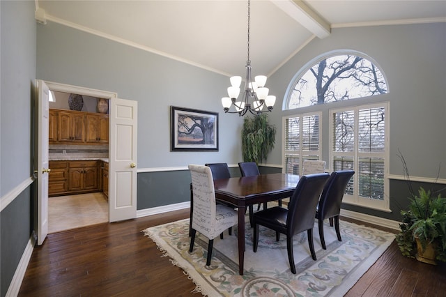 dining space featuring crown molding, dark hardwood / wood-style flooring, lofted ceiling with beams, and a notable chandelier