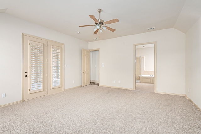 unfurnished bedroom featuring connected bathroom, ceiling fan, light carpet, and vaulted ceiling