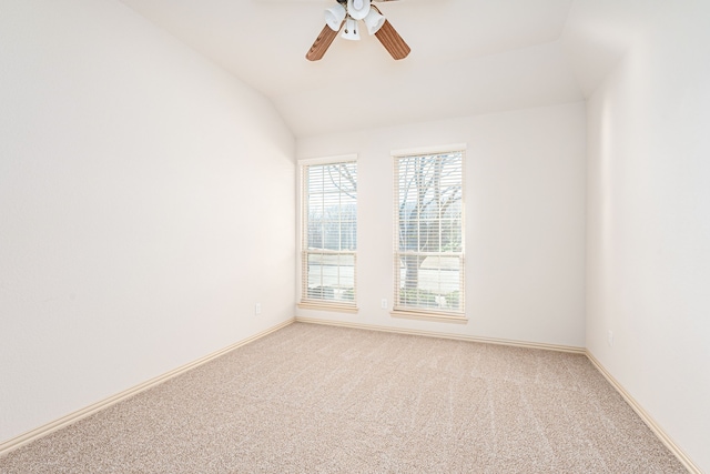 empty room featuring carpet flooring, ceiling fan, and lofted ceiling