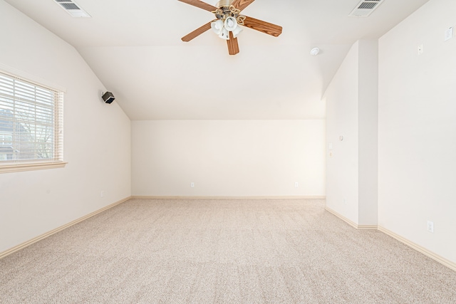 additional living space featuring light carpet, vaulted ceiling, and ceiling fan