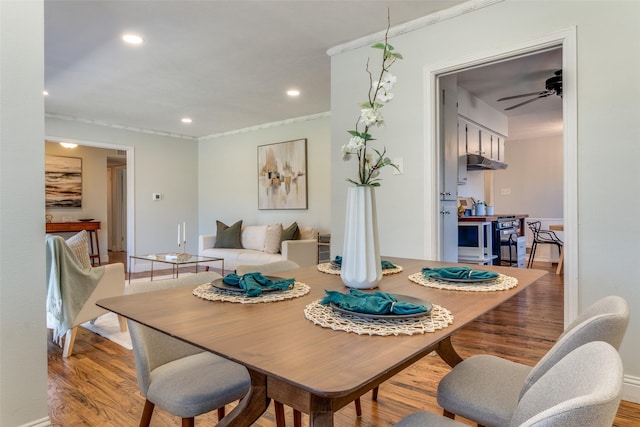 dining space featuring ceiling fan, light hardwood / wood-style floors, and ornamental molding