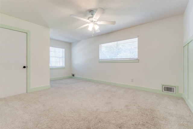 unfurnished bedroom featuring light carpet and ceiling fan