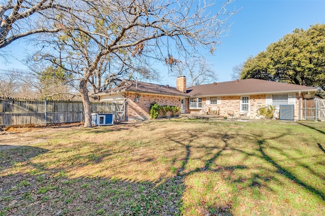 rear view of house with a yard