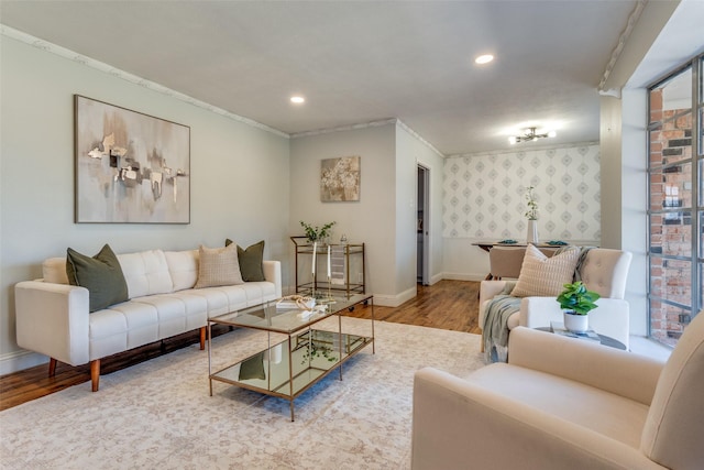 living room with crown molding and hardwood / wood-style floors