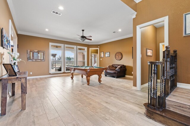 dining room with a fireplace, french doors, ornamental molding, ceiling fan, and light hardwood / wood-style flooring