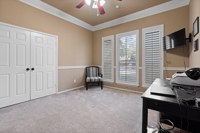 carpeted office space with ceiling fan and ornamental molding