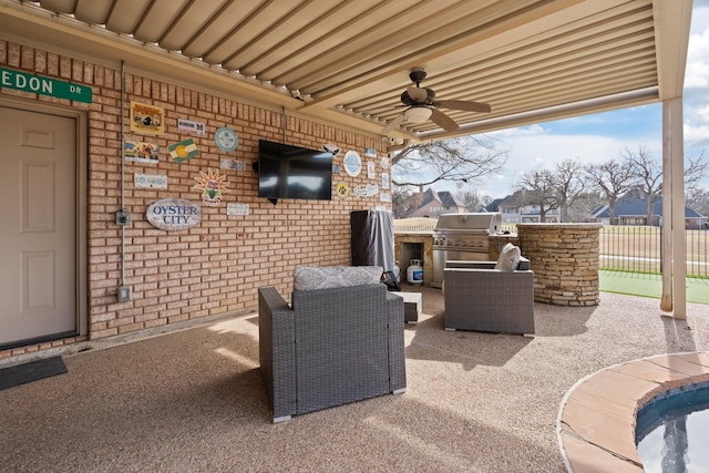 view of patio / terrace with ceiling fan, area for grilling, and an outdoor living space