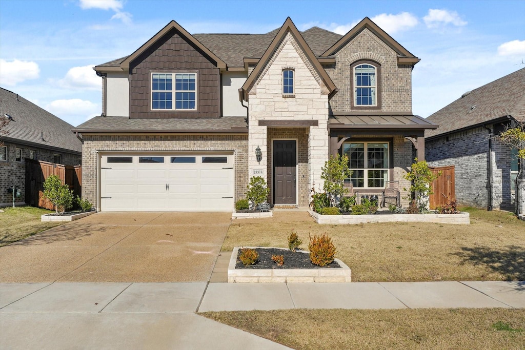 view of front of property with a garage and a front lawn