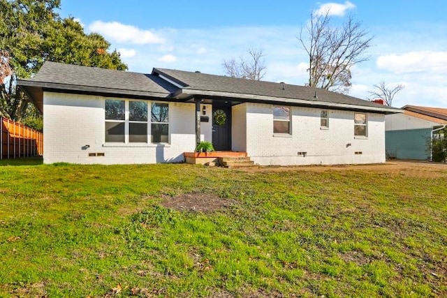 rear view of house featuring a lawn