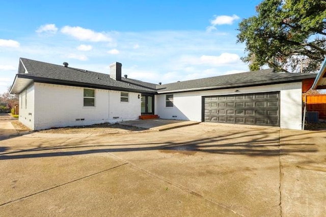 view of front of house featuring central AC unit and a garage