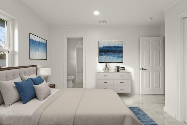 tiled bedroom featuring connected bathroom and ornamental molding