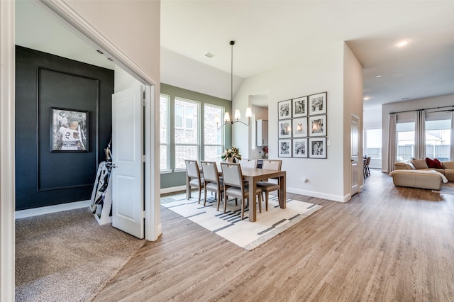 dining space featuring a wealth of natural light, light hardwood / wood-style floors, and a notable chandelier