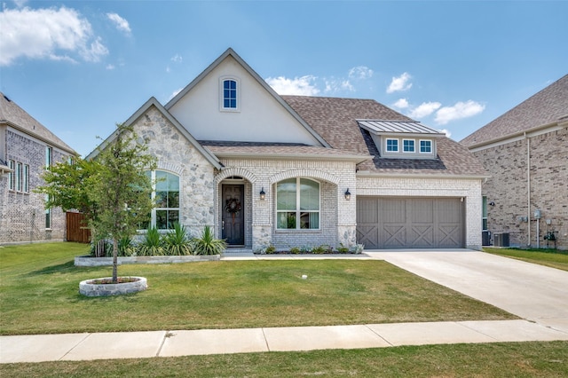 view of front of house featuring central AC unit, a front yard, and a garage