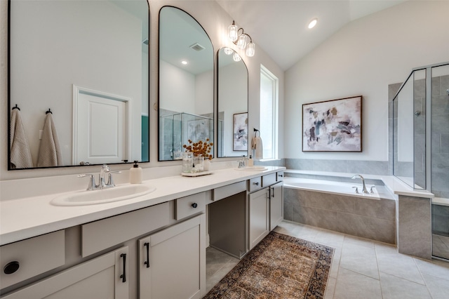 bathroom with tile patterned flooring, vanity, separate shower and tub, and lofted ceiling