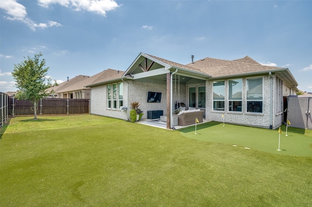 back of property featuring outdoor lounge area, a yard, and a patio