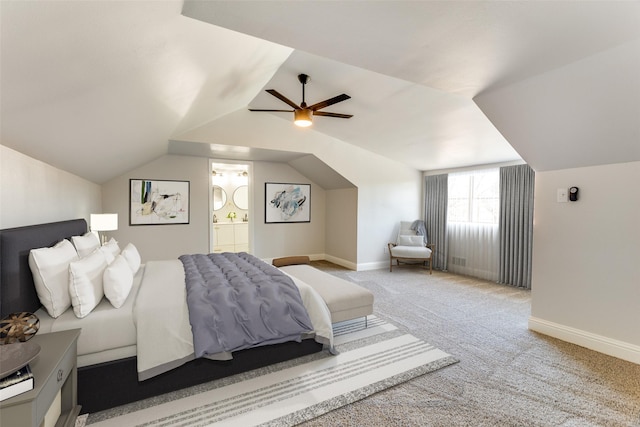 bedroom with ceiling fan, ensuite bathroom, vaulted ceiling, and carpet