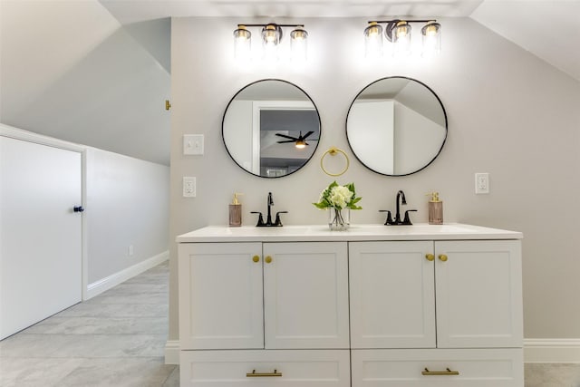 bathroom with vanity and lofted ceiling