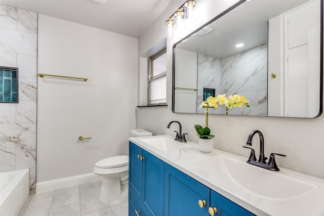 full bathroom featuring tiled shower / bath, vanity, and toilet