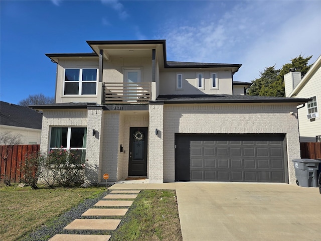 view of front of home featuring a garage and a balcony