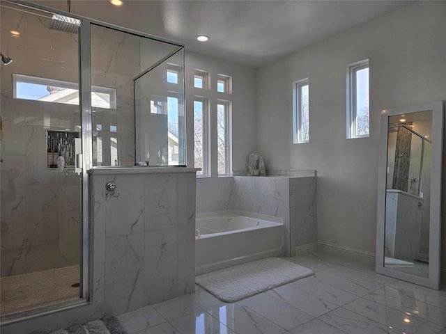 bathroom with plenty of natural light and separate shower and tub