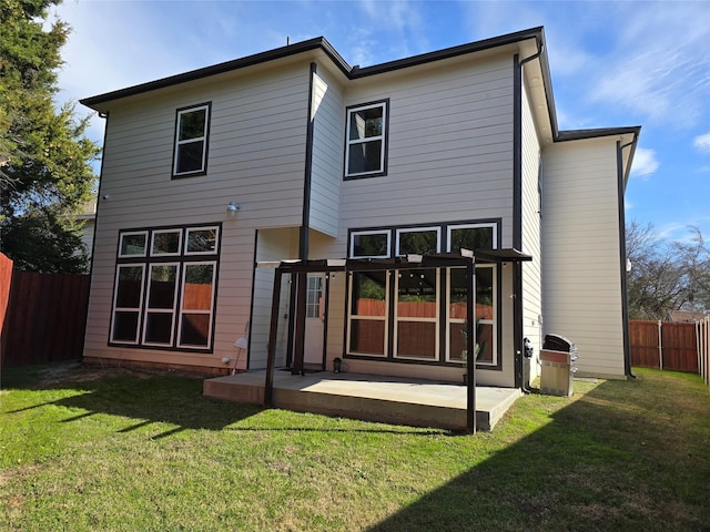 rear view of house with a yard and a patio