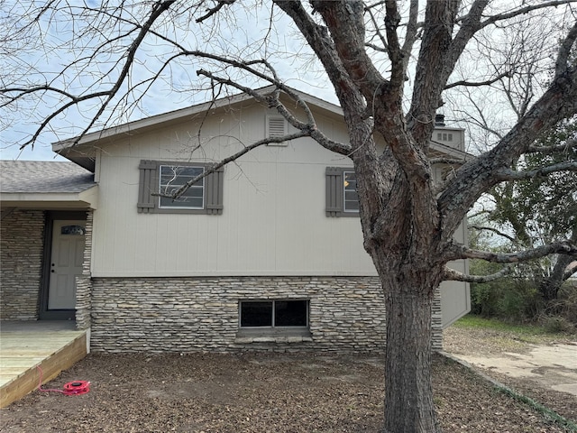 view of side of property featuring a wooden deck