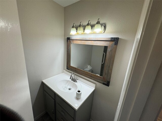 bathroom featuring vanity and toilet