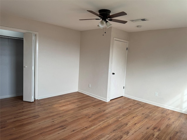 unfurnished bedroom featuring hardwood / wood-style flooring and ceiling fan