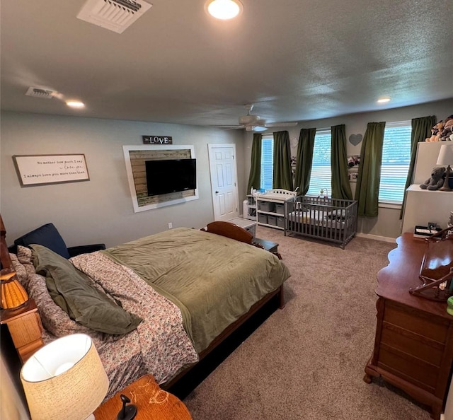 carpeted bedroom featuring a textured ceiling