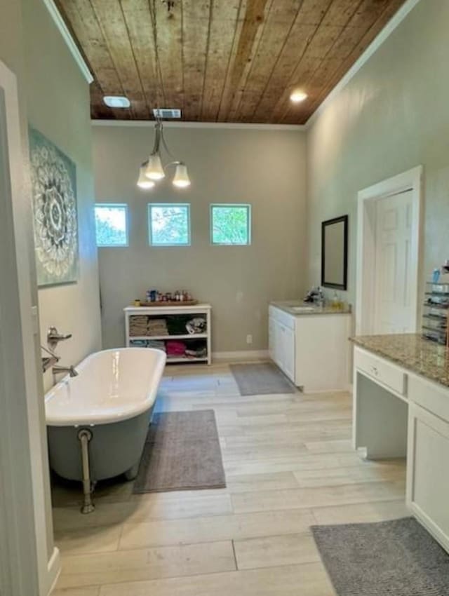 bathroom with a washtub, wood ceiling, crown molding, hardwood / wood-style flooring, and vanity