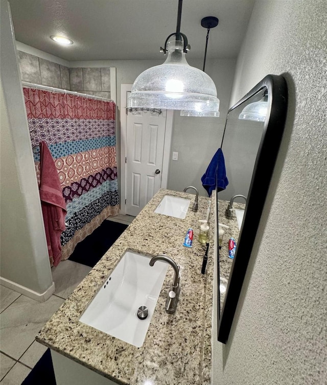 bathroom with a shower with curtain, tile patterned floors, and vanity