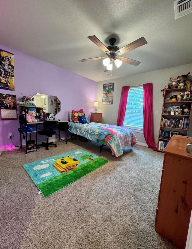 carpeted bedroom with ceiling fan and a textured ceiling