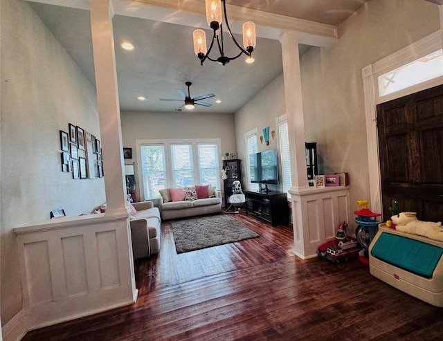 living room featuring dark hardwood / wood-style flooring and ceiling fan with notable chandelier