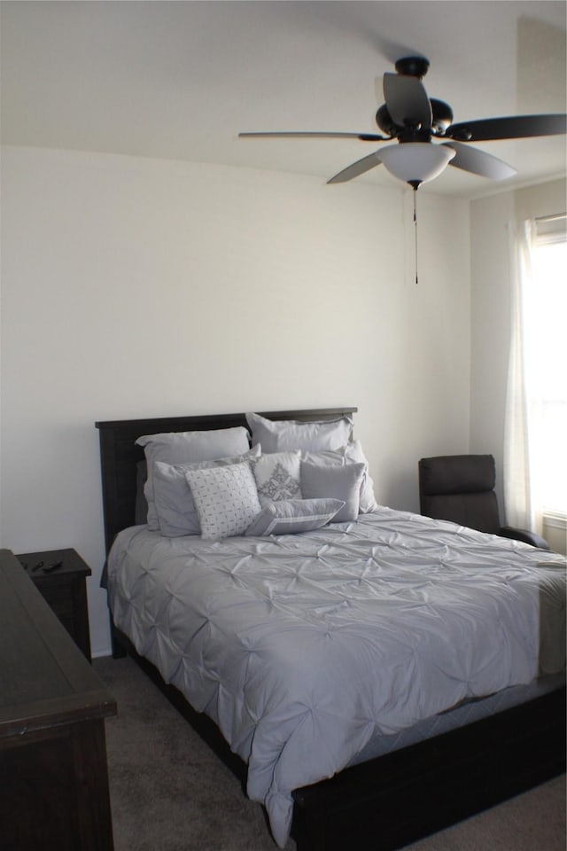 bedroom with ceiling fan and carpet floors