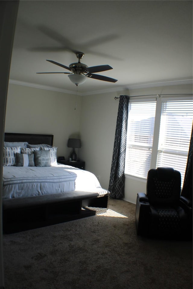 carpeted bedroom featuring ornamental molding and ceiling fan