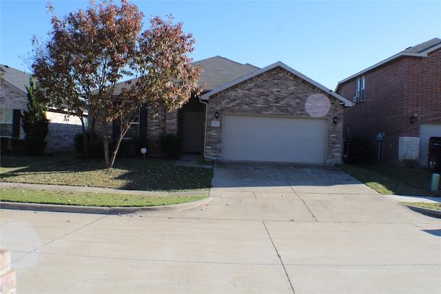 view of front facade featuring a garage and a front lawn