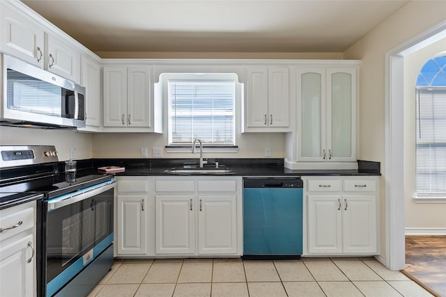 kitchen featuring white cabinets, light tile patterned floors, sink, and appliances with stainless steel finishes