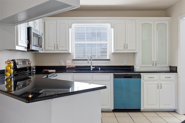 kitchen with light tile patterned floors, stainless steel appliances, white cabinetry, and sink