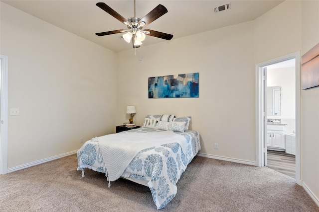 carpeted bedroom featuring ceiling fan and ensuite bathroom